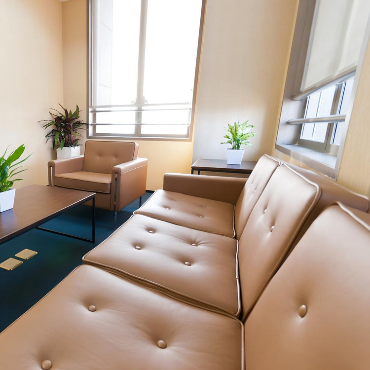 Modern beige imitation leather sofa set in a bright living room, showcasing premium PVC faux leather texture and comfortable design