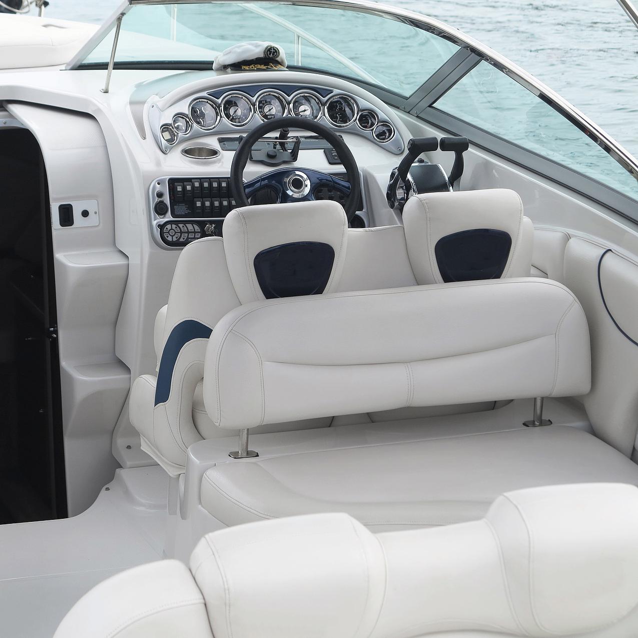 Luxury yacht interior with white marine grade vinyl fabric on seats and helm area, showcasing waterproof and durable PVC leather suitable for marine environments